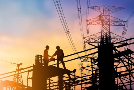 Silhouette Good deal two engineer business people shaking hands  heavy industry and safety at work concept over blurred natural background sunset pastel.