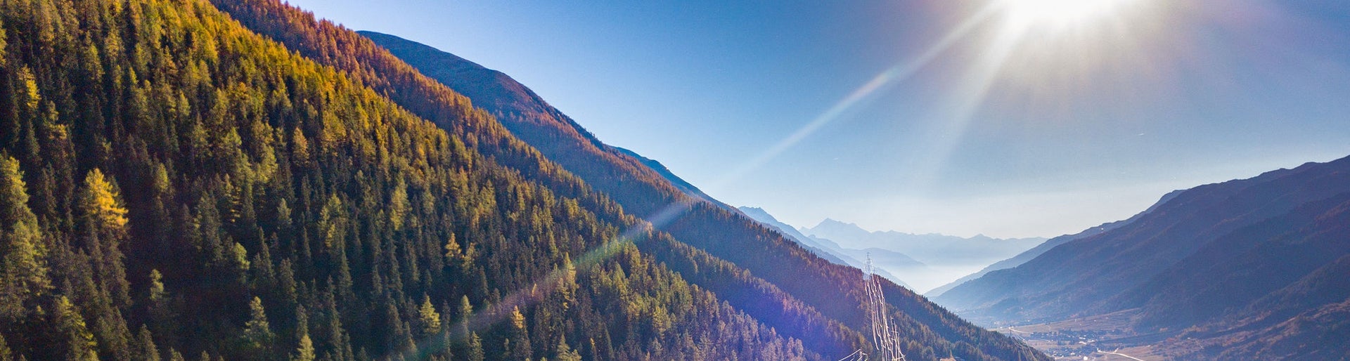 Aerial view of power line pylon in mountaineous area in Switzerland, Europe